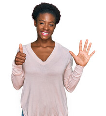 Wall Mural - Young african american girl wearing casual clothes showing and pointing up with fingers number six while smiling confident and happy.