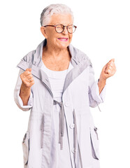 Wall Mural - Senior beautiful woman with blue eyes and grey hair wearing casual clothes and glasses excited for success with arms raised and eyes closed celebrating victory smiling. winner concept.