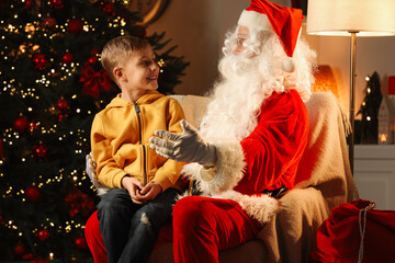 Canvas Print - Merry Christmas. Little boy with Santa Claus in room