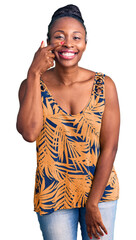 Canvas Print - Young african american woman wearing casual clothes pointing with hand finger to face and nose, smiling cheerful. beauty concept