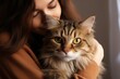 © Tisha - Portrait of young woman holding cute siberian cat with green eyes. Female hugging her cute long hair kitty. Background, copy space, close up. Adorable domestic pet concept.