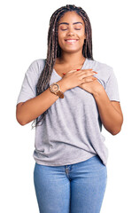 Poster - Young african american woman with braids wearing casual clothes smiling with hands on chest with closed eyes and grateful gesture on face. health concept.