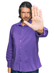 Poster - Middle age handsome man wearing business shirt doing stop sing with palm of the hand. warning expression with negative and serious gesture on the face.