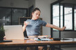 © Satori Studio - Business woman relaxing with hands behind her head and sitting on an office chair