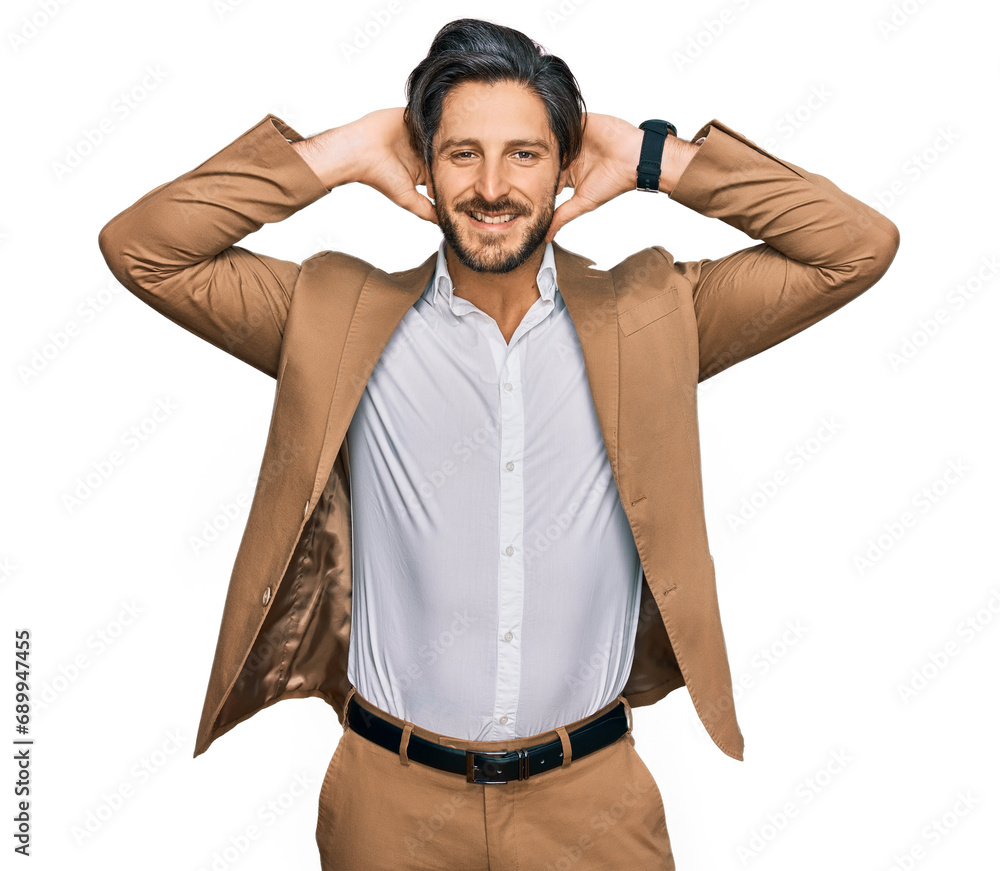 Young hispanic man wearing business clothes relaxing and stretching, arms and hands behind head and neck smiling happy