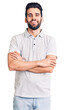 © Krakenimages.com - Young handsome man with beard wearing casual polo happy face smiling with crossed arms looking at the camera. positive person.