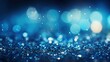 A close-up of a blue glitter surface with a varying intensity of blue shades and soft bokeh lights, creating an abstract, cosmic-like appearance.