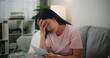 © Johnstocker - Portrait of Young Asian Woman having financial problems paychecks paper receipt bill statement ,calculating on calculator monthly expenses debt,planning budgets of monthly personal balance at home.