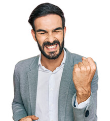 Canvas Print - Young hispanic man wearing business clothes celebrating surprised and amazed for success with arms raised and eyes closed. winner concept.