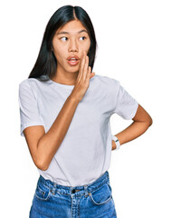 Sticker - Beautiful young asian woman wearing casual white t shirt hand on mouth telling secret rumor, whispering malicious talk conversation