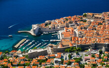 Dubrovnik, Croatia. View On The Old Town From High Mountain. Top View Rocks At On The Old Castle And Blue Sea. Vacation And Adventure. Travel Image