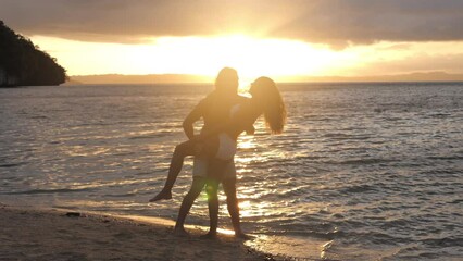 Poster - Sunset, beach and couple dance in nature with love, hug or celebration, bonding or fun outdoor. Energy, freedom and people at the ocean for sunrise, adventure or moving at sea with lens flare romance