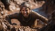 Woman climbing out of a muddy pit