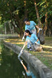 © Prathankarnpap - Happy young volunteer women collecting trash in the public park. Environmental protection and charity concept