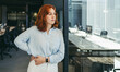 © Jacob Lund - Confident female entrepreneur contemplating business strategies in office
