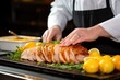 © primopiano - chef placing lemon slices on pork loin