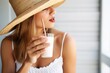 female sipping horchata in a straw hat