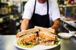 man in apron delivering sandwich with coleslaw at deli