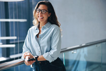 Successful Woman Smiling While Standing In A Business Office