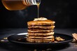 pouring maple syrup on a stack of vegan pancakes