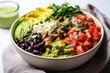 side view of a burrito bowl filled with diverse ingredients