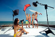 Surfer and kiter boys with beautiful girls group have photoshooting on beach