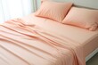 Peach fuzz sheet set from a bed with pillows, in the style of post processing, dullcore, smooth surface, ultra detailed, organic material