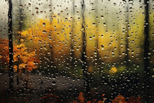 Blurred Autumn Landscape Behind Wet Glass With Raindrops