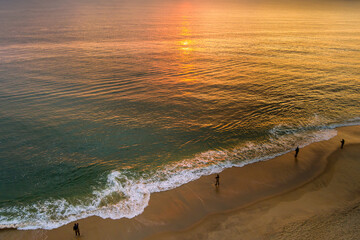 It s sunny morning fisherman is catching fish on ocean during sunrise