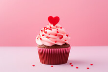 Chocolate Muffin (cake) Decorated With Cream And A Red  Heart For Valentine's Day On A Pink Background