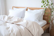 © Cla78 - Closeup on a bed with white pillows in scandinavian style near a plant