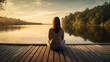 Young woman in serene meditation pose on wooden pier overlooking calm lake at sunrise, Capture peaceful ambiance and soft morning light, AI Generated