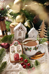 Wall Mural - A cup of coffee and house shaped gingerbread cookie for Christmas