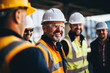 © เลิศลักษณ์ ทิพชัย - A group of smiling engineers and professionals wearing hard hats and helmets on a construction site