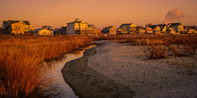 Beach Houses And Marshland At Winter Dawn On The Coastal Village In New England With Curved Sandy Footpath At Low Tide