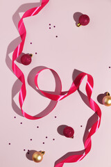 Wall Mural - Christmas minimalistic composition on pink background. Mockup for cosmetic.