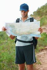 Canvas Print - Man, hiking and map for direction, nature and guide on trail, fitness and exercise on holiday. Male person, lost and documents for information, travel and journey or adventure to forest for cardio