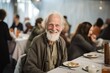 © Bargais - Happy homeless old man sitting at a table at a charity dinner.