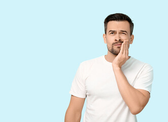 Poster - Handsome man with toothache on blue background