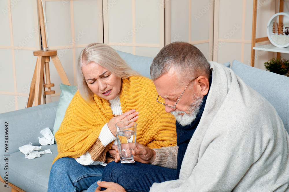 Sick mature couple sitting at home