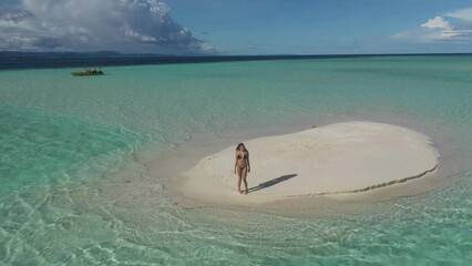 Poster - Woman at sea, walking or drone of island for holiday or summer vacation in Indonesia for travel. Beach environment, aerial view or female person on sand on destination in calm water, ocean or nature