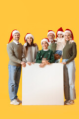 Canvas Print - Big family in Santa hats with blank poster on yellow background