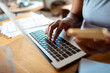 © Marko Geber - Woman typing on laptop keyboard at home