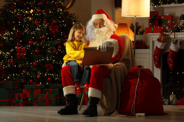 Sticker - Merry Christmas. Santa Claus with little girl reading her letter at home