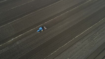 Wall Mural - Farmers drive tractors to level up land, North China