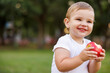 © Impact Photography - Toddler boy eating an apple and smiling