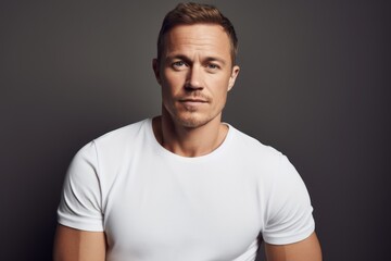 Wall Mural - Attractive young man in white t-shirt. Studio shot.