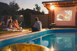 © Impact Photography - Friends having fun watching a movie by the swimming pool