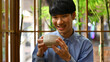 Close up with A Happy Young Asian man enjoying Japanese traditional matcha tea, The concept of drinking green tea for health