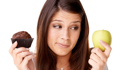 Sticker - Face, choice and apple or muffin with a woman in studio isolated on a white background for food decision. Doubt, health or nutrition with a confused young person holding fruit and dessert options